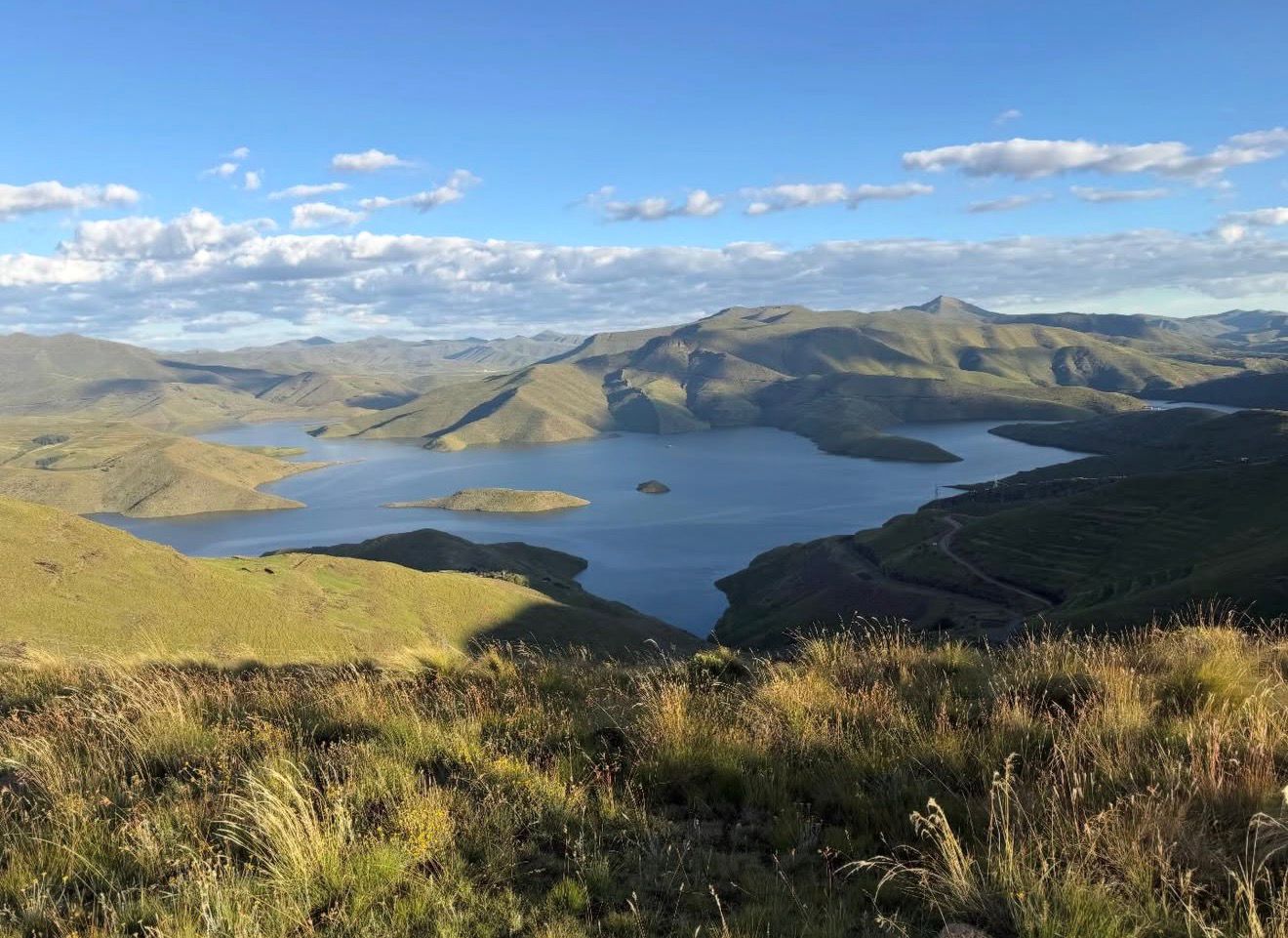 Bridge spanning river gorge with green Lesotho highlands