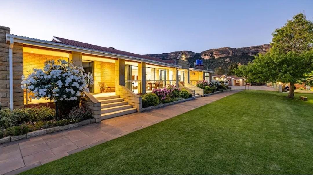 Venue exterior at golden hour with mountain backdrop